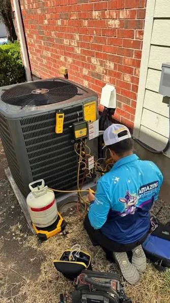 Technician maintaining an outdoor residential air conditioning system
